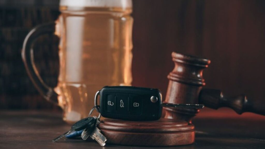 DUI concept of car keys, beer mug, and gavel together.
