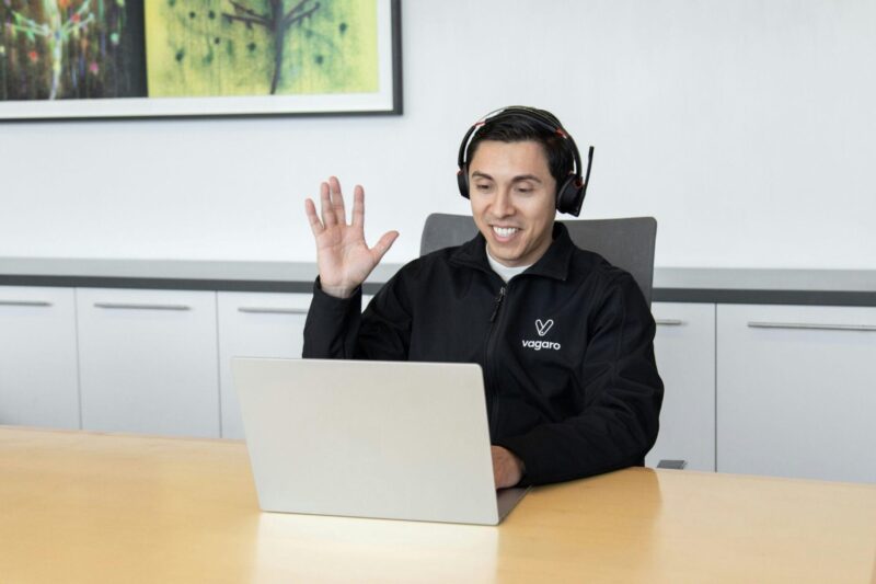 IT support technician wearing a headset while working at a laptop